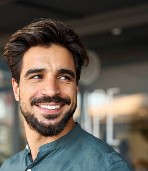 Smiling,Young,Business,Man,Standing,Looking,Away,In,Office.,Happy